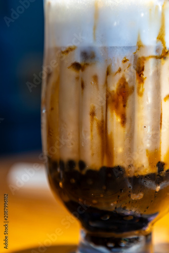 A close-up of classic brown sugar bubble tea with images of a crystal-clear, chilled drink in a glass.