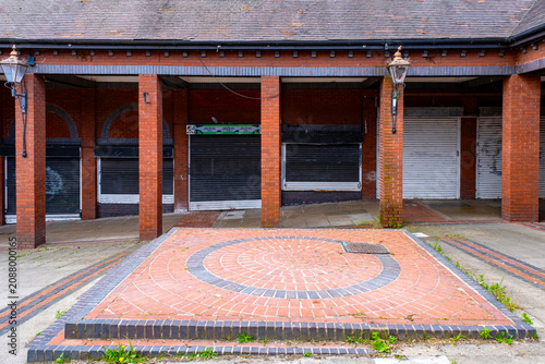 Closed down and shuttered shops in front of a bandstand