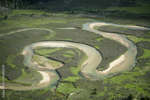 Aerial Close-up of Meandering Rivers and Wetlands on Genyen South Route