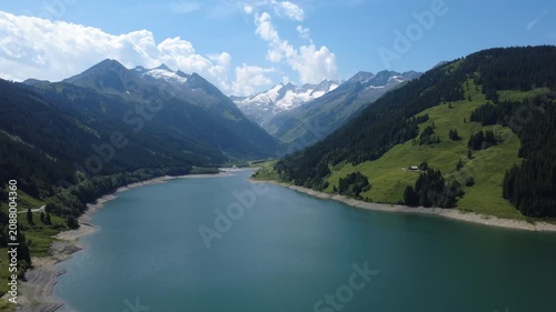 Panoramic Summer Aerial View of an Alpine Lake and Majestic Mountains in the Austrian Alps.