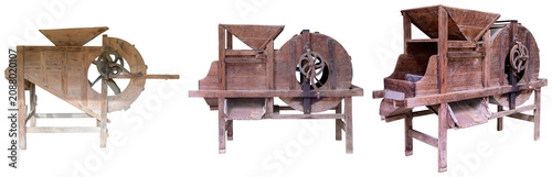 Foto Three antique wooden threshing machines or grain separators isolated on a white