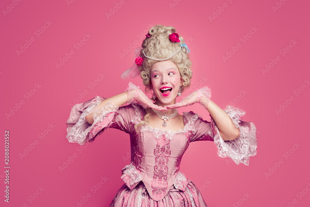 Fototapeta premium Photo of positive lady princess in antique baroque style dress hold hands near face look empty space isolated pink color background