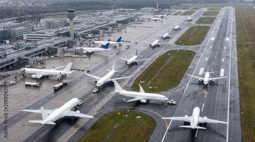 Aerial view of a busy international airport apron with many commercial airplanes
