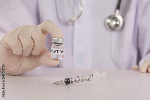 Fotografie Functional medicine clinic concept with doctor holding peptide vial and syringe