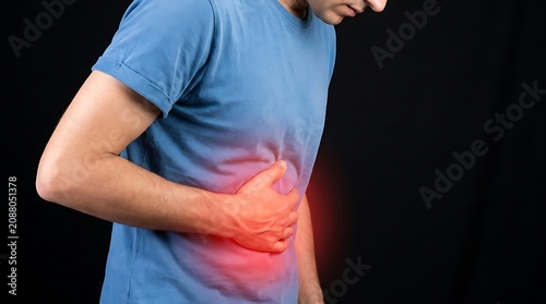 Man in blue shirt clutching his stomach in pain with glowing red area indicating severe abdominal discomfort