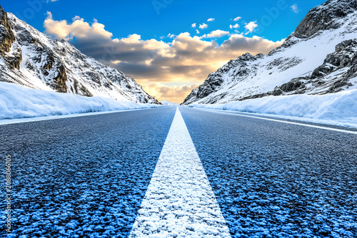 Empty Road Through Snowy Mountains