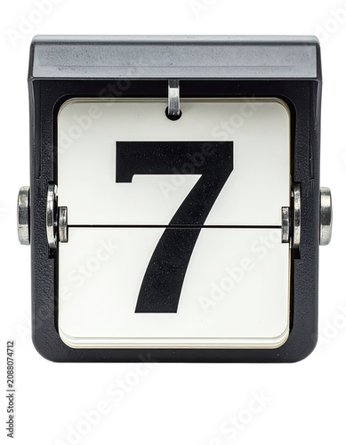 A close-up of a vintage flip clock displaying the number seven.