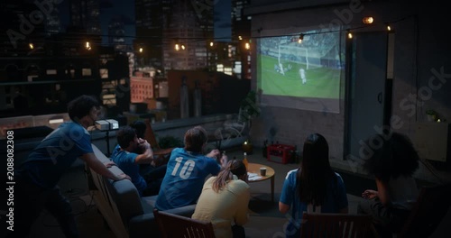 Friends Gather on a Rooftop to Watch a Soccer Football Championship Match. They Enjoy Sports Entertainment, Cheering and Celebrating Teams Championsip Victory. City View Terrace World Tournament Cup