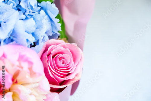 Fényképezés Colorful bouquet with pink rose and blue flowers arranged for special occasion i