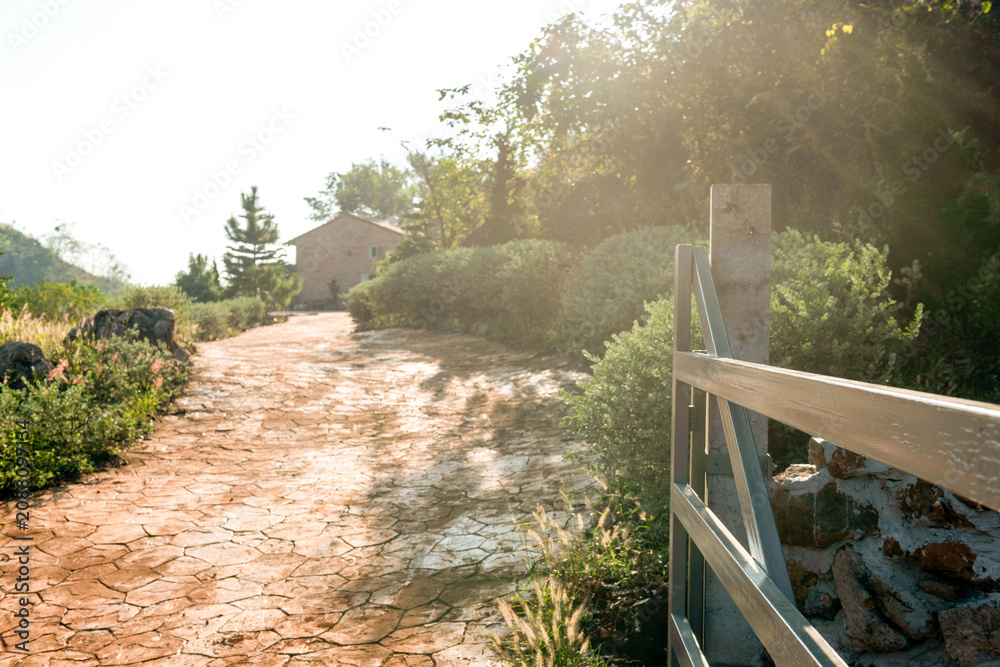 Naklejka premium Rustic path leading to cottage.