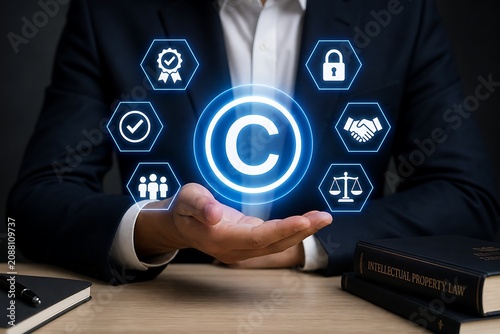 Businessman holding glowing copyright symbol with legal and security icons above desk