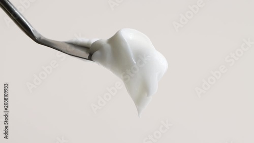 Sample of cosmetic cream, shampoo, lotion close-up, front view, changing lighting.