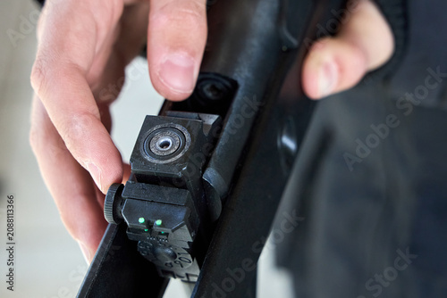 Φωτογραφία Person hand loaded lead pellet into breech of black airgun rifle for target shoo
