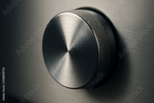 Close-up of a brushed metal control knob on an appliance panel