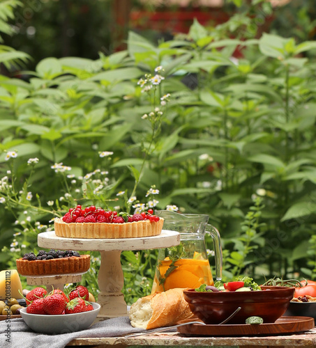 outdoor picnic with fresh berries and baked goods