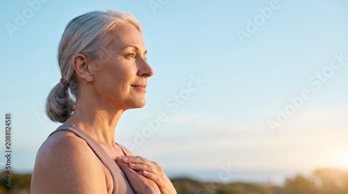 Mature Woman Practicing Mindfulness Meditation at Sunrise