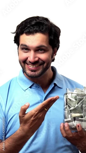 Handsome bearded Indian man holding a glass jar filled with ₹500 notes, radiating positivity and confidence, standing isolated on a white background, saving concept
