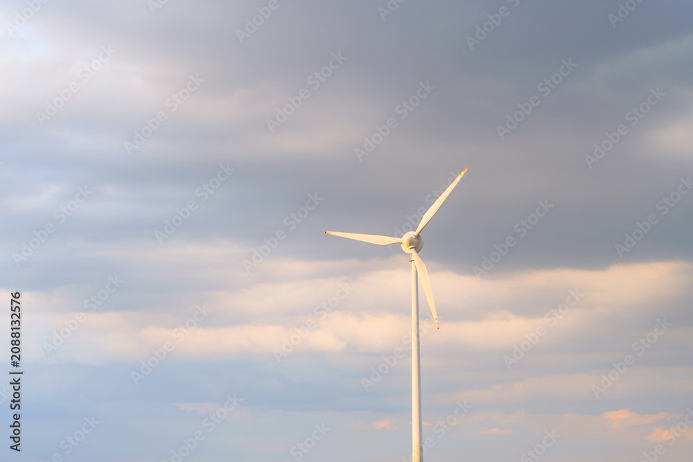 Fototapeta premium Electric power turbine with cloudy background