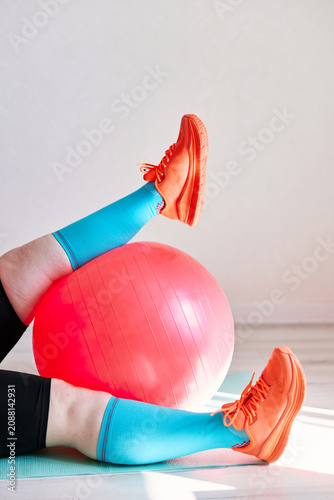 Person exercising with fitness ball at home