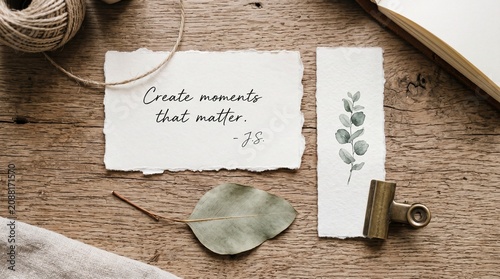 Create moments that matter quote on paper with rustic wood