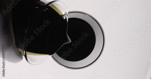 Scientist chemist pouring used engine oil from glass into beaker., Top view
