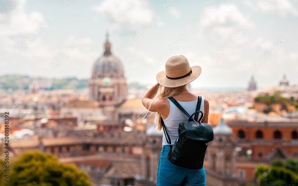 Fototapeta premium ome Europe Italia travel summer tourism holiday vacation background -young smiling girl with mobile phone camera and map in hand standing on the hill looking on the cathedral Vatican