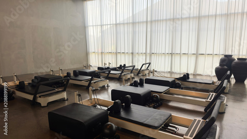Modern Pilates reformer machine in a bright minimalist fitness studio