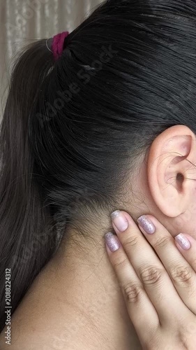 Close up of woman palpating lymph nodes in neck, medical self-check, health monitoring and wellness concept.