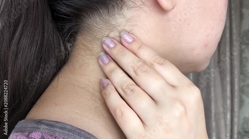 Close up of woman palpating lymph nodes in neck, medical self-check, health monitoring and wellness concept.