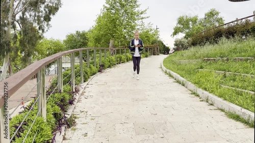 Lifestyle portrait of young woman using a smartphone outdoors