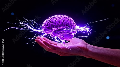 Hand holding glowing brain with electric sparks