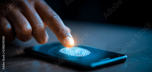 Fingerprint authentication unlocks modern smartphone screen with futuristic lighting