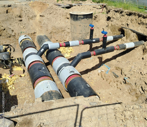 Underground Insulated District Heating Pipes in Construction Trench With Valves and Connections.