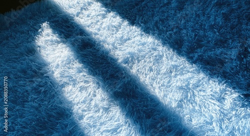 Soft, fluffy blue rug with diagonal light and shadow patterns