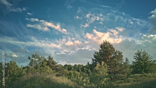 Beautiful dramatic clouds timelapse evening sky forest edge.Ukraine. Fast moving colorful cumulus clouds sunset golden hour. Majestic nature scenery, cinematic countryside background, weather changing
