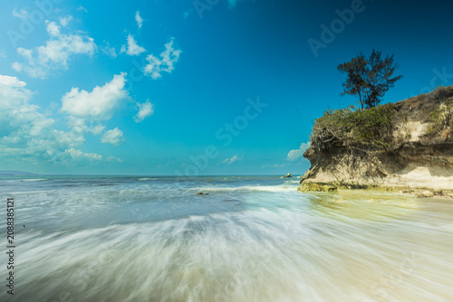 Cuadro en lienzo The sky blazes blue, with the midday sun beating down fiercely upon Sumba—upon the sea and the land alike