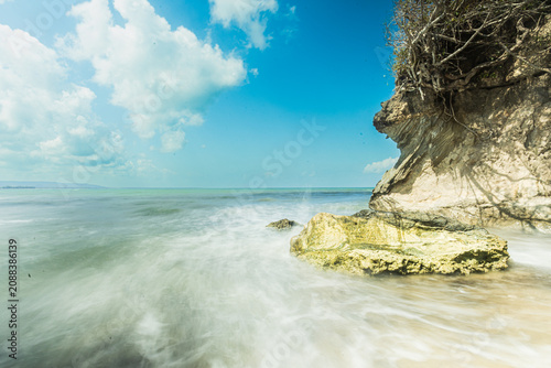 Obraz na płótnie The sky blazes blue, with the midday sun beating down fiercely upon Sumba—upon the sea and the land alike