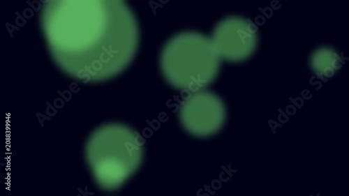 Green lights float softly against a dark background