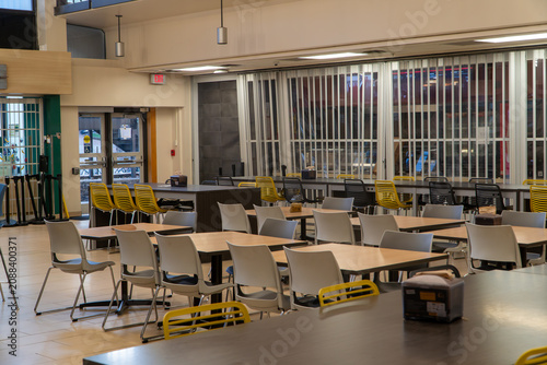 Картината върху платно Modern Empty Cafeteria Dining Hall with Rows of Tables and Yellow & Gray Chairs,