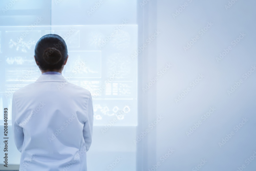 Fototapeta premium Scientist analyzing data on digital screens in a modern laboratory setting