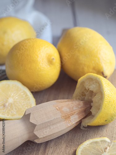 Obraz na plátně lemons squeezed with a wooden reamer on a wooden board