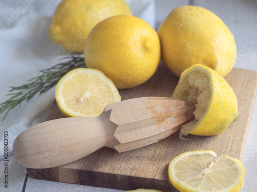 Принти на полотні lemons squeezed with a wooden reamer on a wooden board