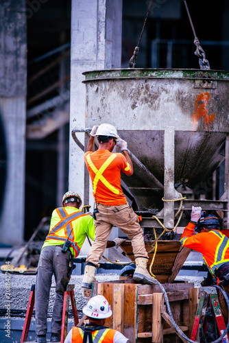 Photography Construction Crew pouring concrete at a City jobsite