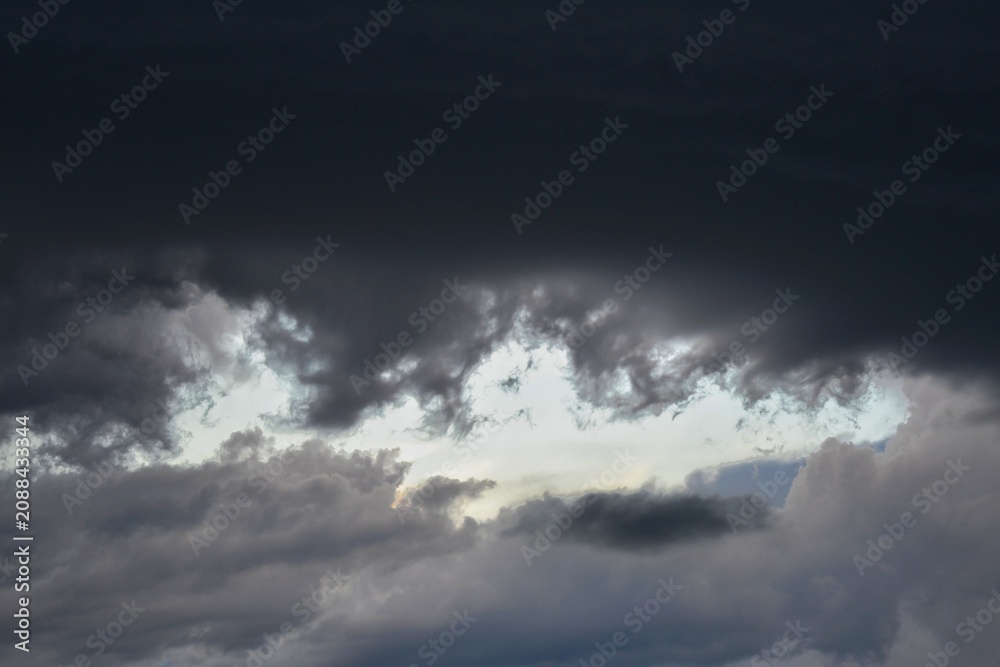 Obraz premium Dramatic storm clouds background with light breaking through.