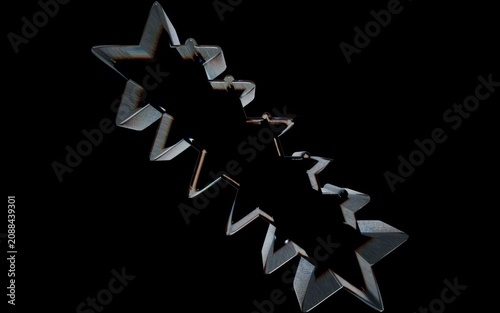 Metallic starshaped cookie cutter isolated on black background
