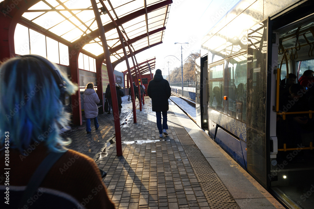 Fototapeta premium tram stop and several passengers