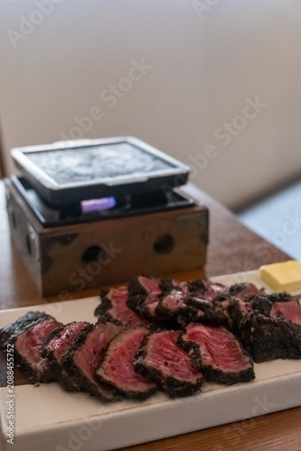 Set of Black Gyukatsu or beef cutlet served with butter. A traditional Japanese food that consists of a deep-fried beef cutlet.