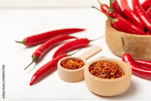 Obraz na płótnie Chili pepper and chili powder on a wooden table