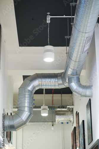 Industrial ventilation ducting and extraction system inside a modern industrial warehouse factory workshop. Healthy clean air for good safe working conditions