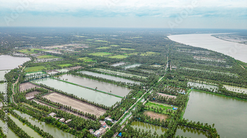 Fotografie Aerial of prawn cultivation farm with structured ponds and surrounding greenery